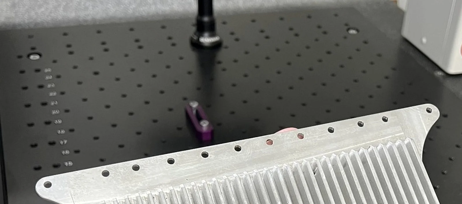Measuring probe above the granite plate in RJ's climate-controlled inspection lab
