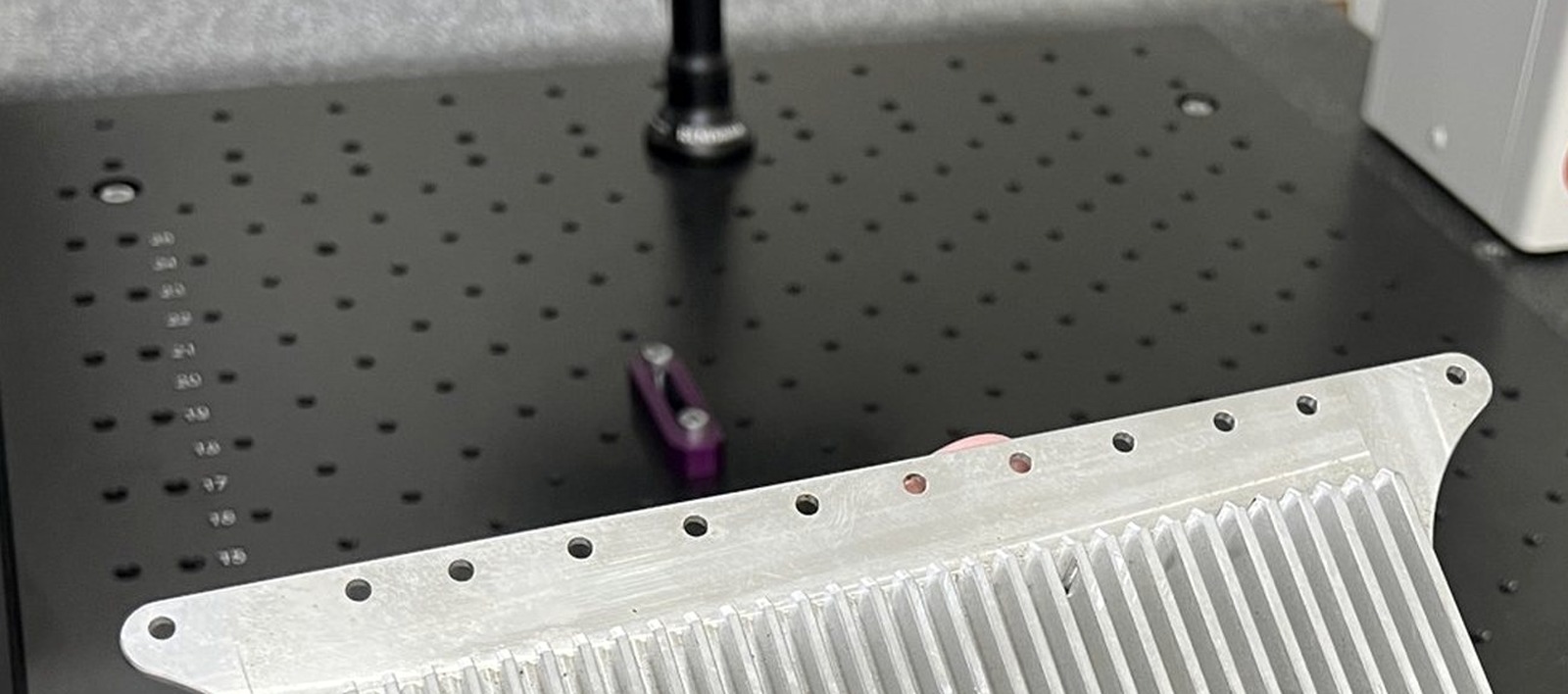 Measuring probe above the granite plate in RJ's climate-controlled inspection lab