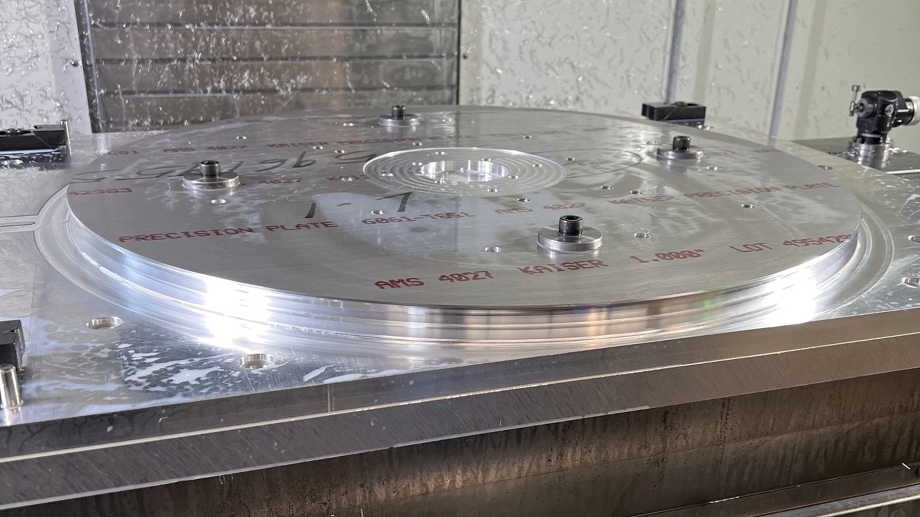 Large aluminum plate fixtured on a vertical machining center table at RJ Enterprises
