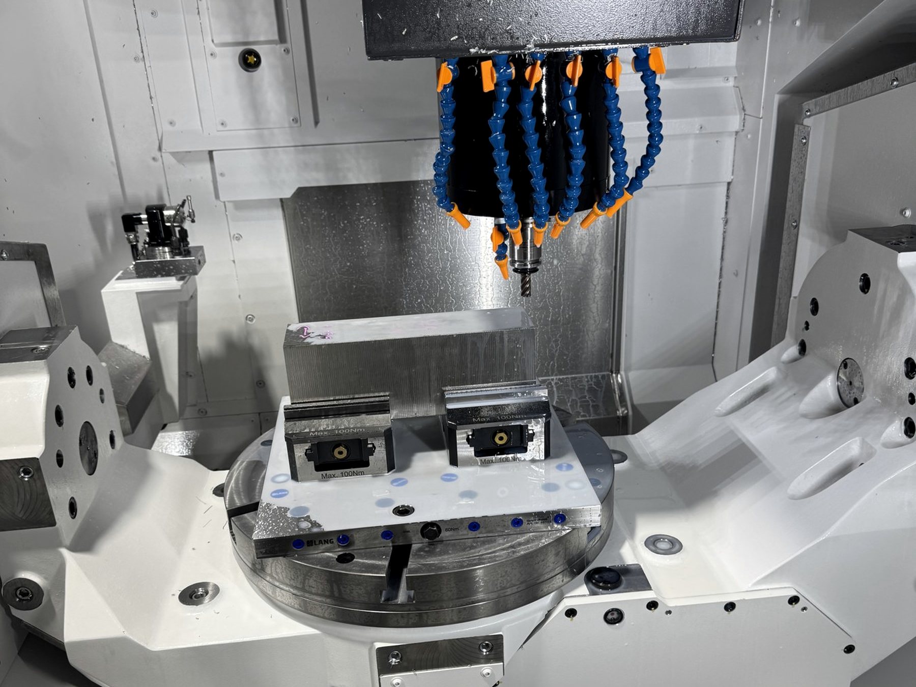 Okuma machining center spindle and tooling above a fixtured part