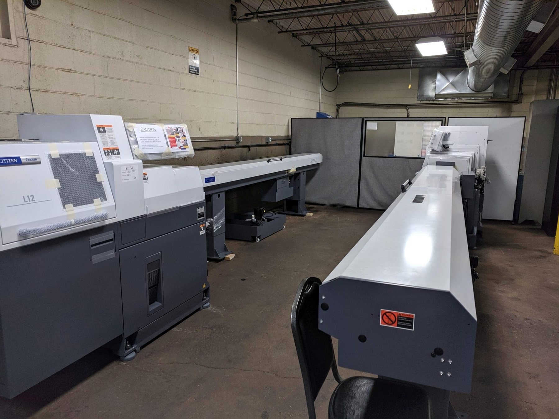 Row of CNC machining centers on the RJ Enterprises shop floor
