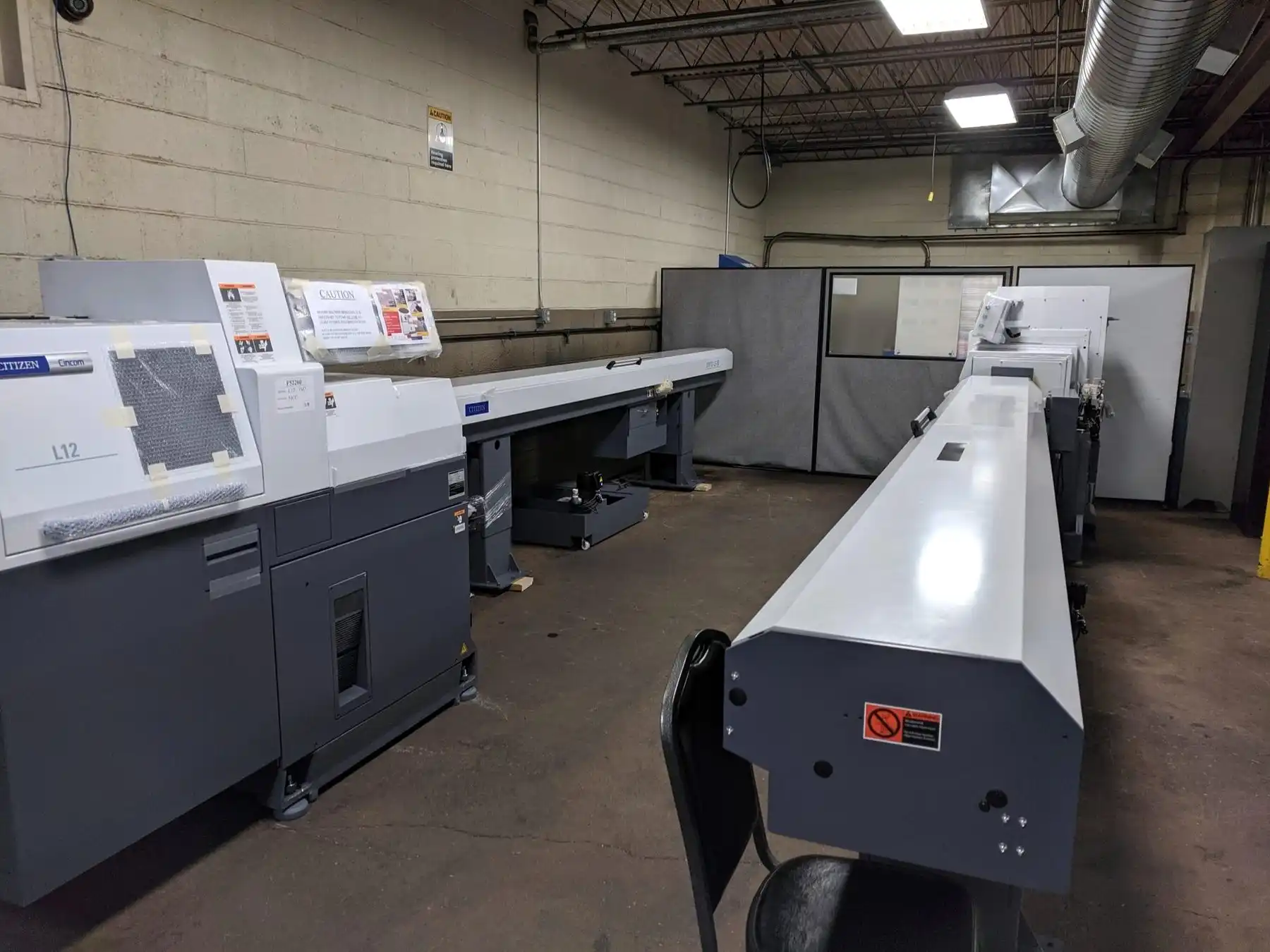 Row of CNC machining centers on the RJ Enterprises shop floor
