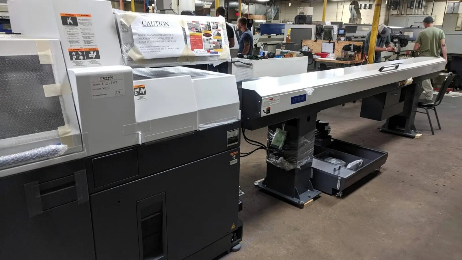 Row of Citizen Swiss-type lathes with bar feeders